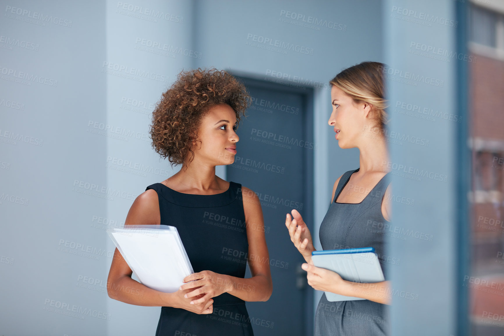 Buy stock photo Cropped shot of two businesswomen having a discussion in an office