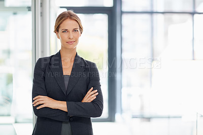 Buy stock photo Portrait of a confident young businesswoman standing in a modern office