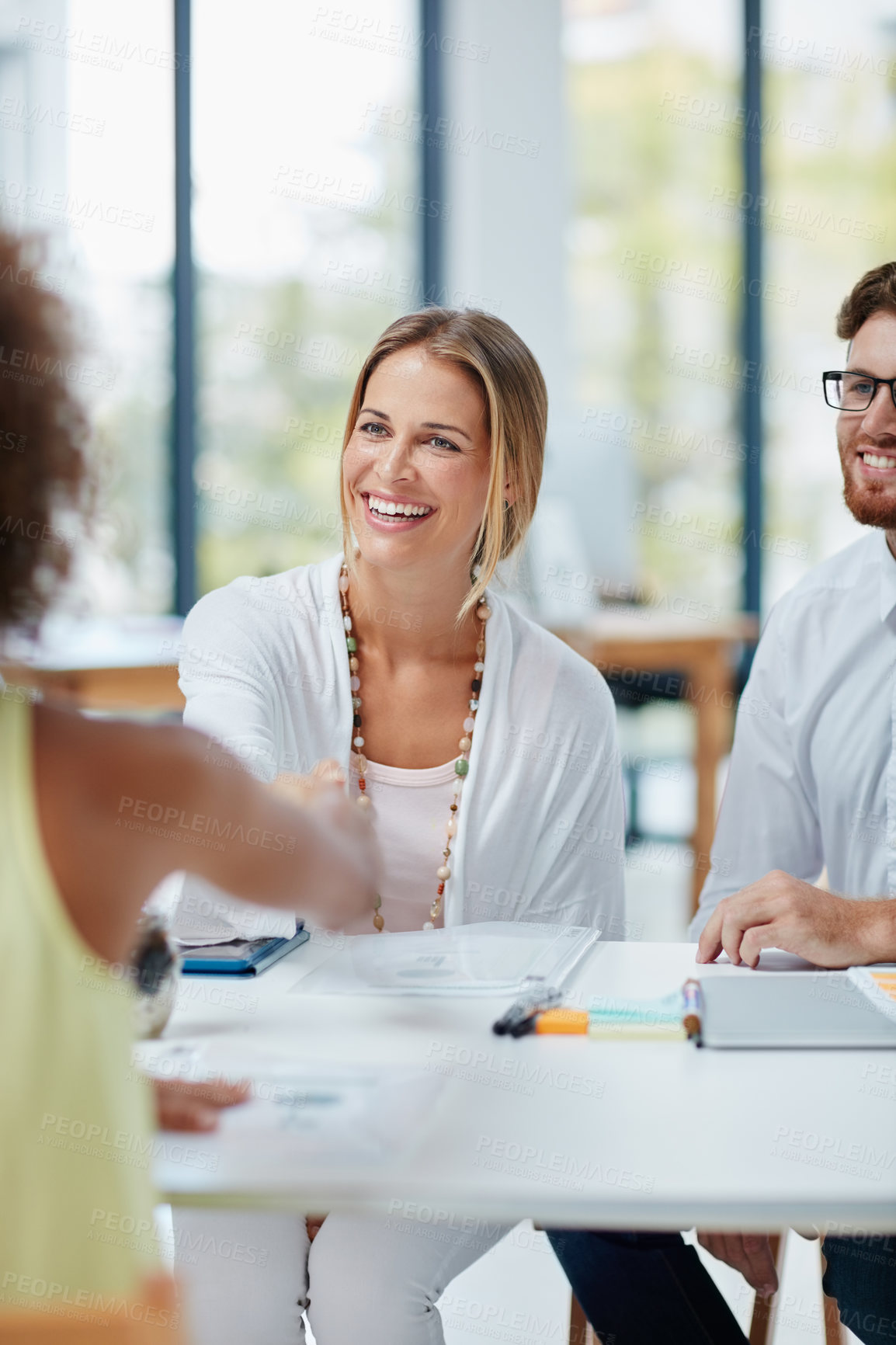 Buy stock photo Shot of a group of businesspeople meeting a new colleague