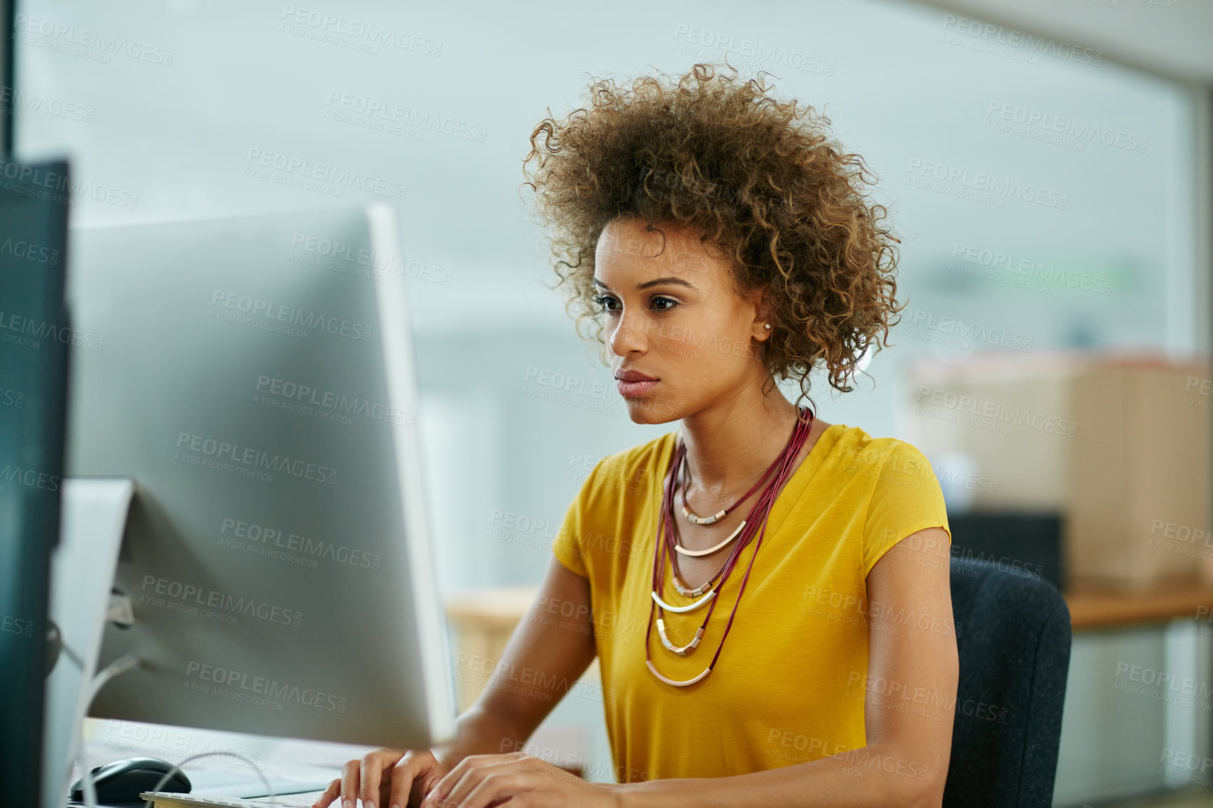 Buy stock photo Shot of a businesswoman working on her computer in the office