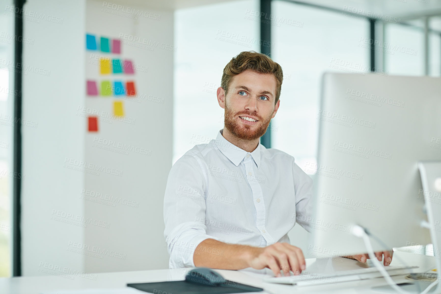 Buy stock photo Shot of a businessman working on his computer in the office