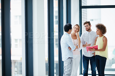 Buy stock photo Shot of a group of colleagues having a conversation in the office