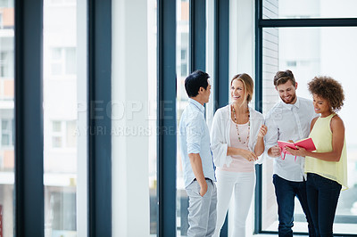 Buy stock photo Shot of a group of colleagues having a conversation in the office
