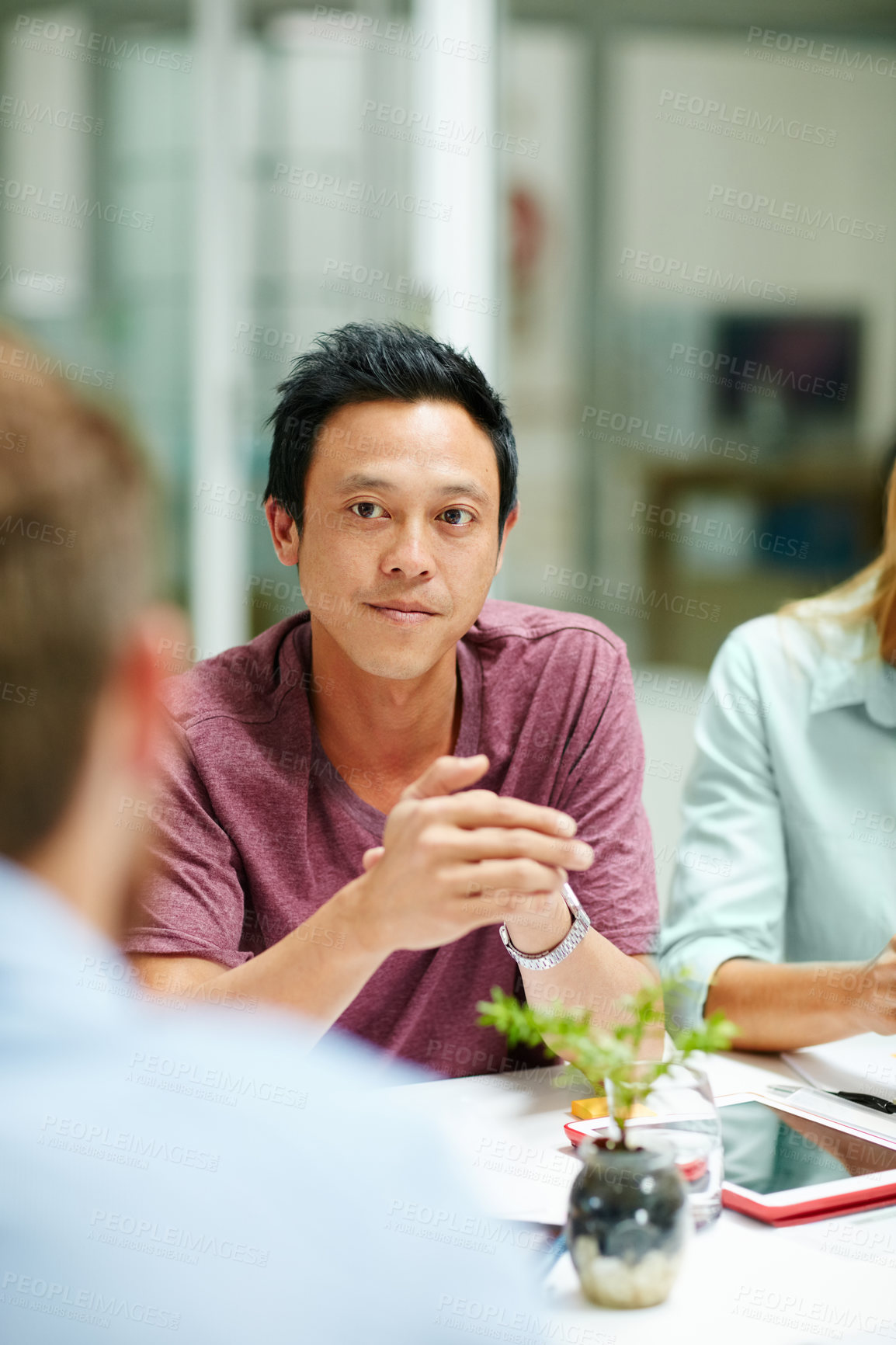 Buy stock photo Shot of a group of businesspeople talking together around a table in an office