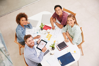 Buy stock photo High angle portrait of a group of businesspeople working together around a table in an office