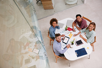 Buy stock photo High angle portrait of a group of businesspeople working together around a table in an office