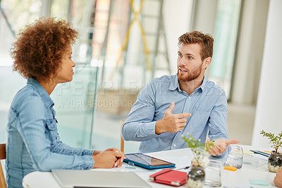Buy stock photo Cropped shot of two businesspeople having a meeting in an office