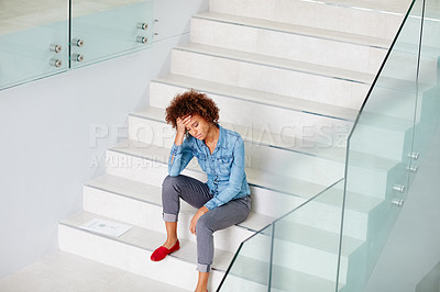 Buy stock photo Shot of a young woman looking upset while in her office