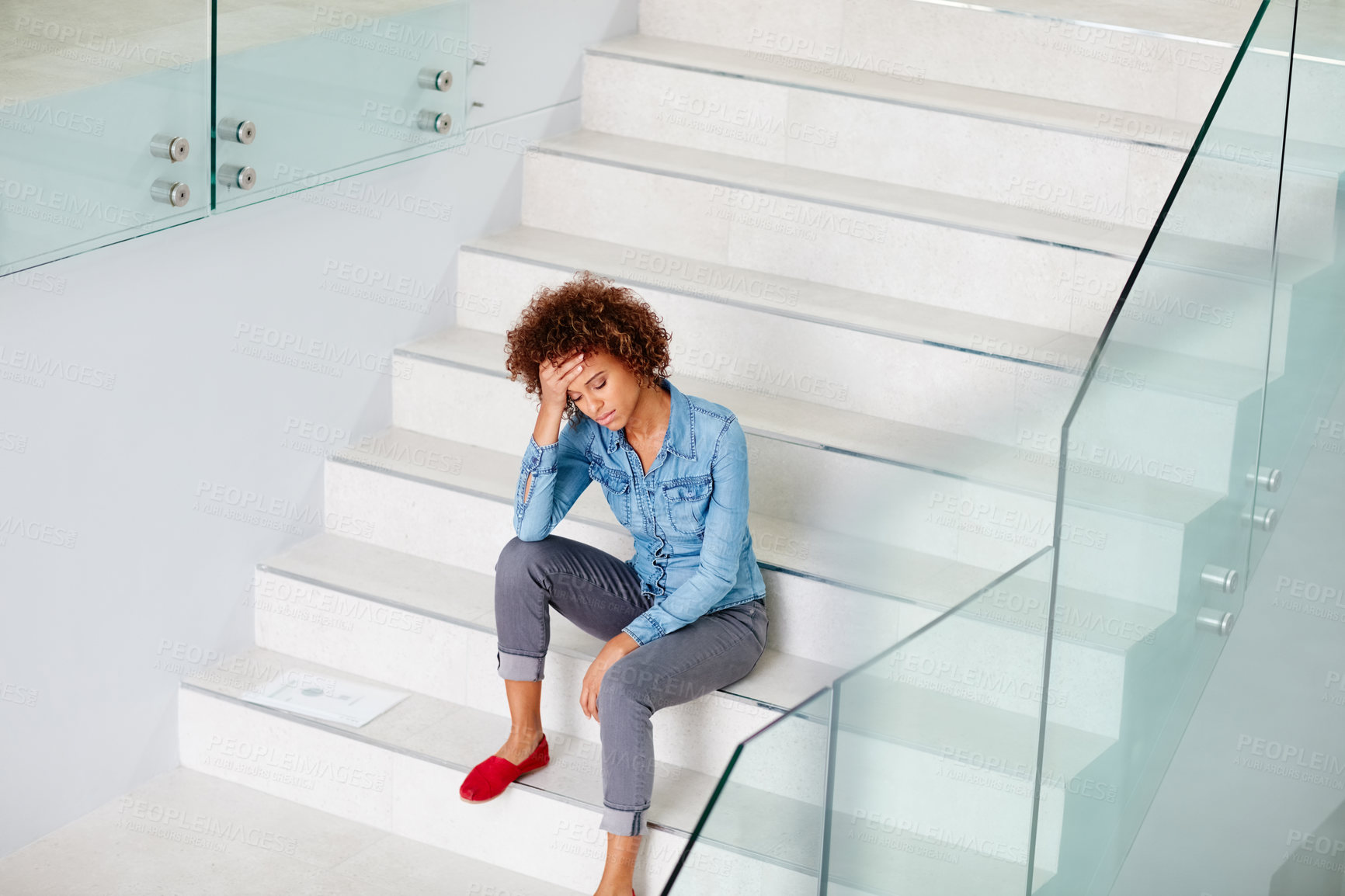 Buy stock photo Shot of a young woman looking upset while in her office