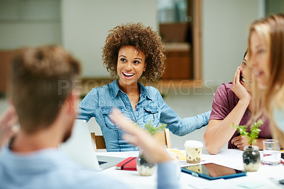 Buy stock photo Shot of a group of businesspeople talking together around a table in an office