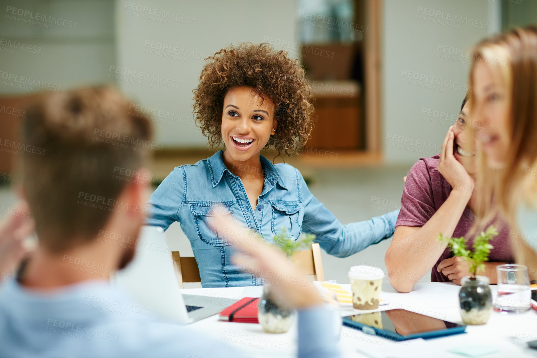 Buy stock photo Shot of a group of businesspeople talking together around a table in an office