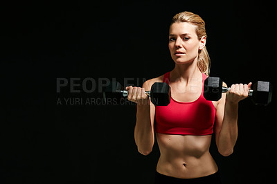 Buy stock photo Cropped portrait of an attractive young woman working out with dumbbells