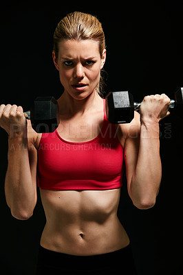 Buy stock photo Cropped portrait of an attractive young woman working out with dumbbells