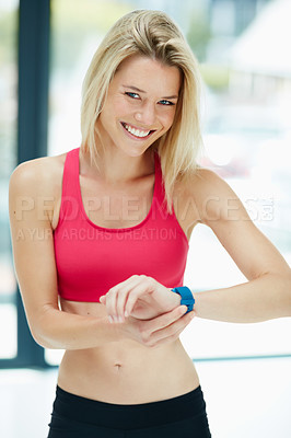 Buy stock photo Cropped portrait of an attractive young woman checking the time during a workout