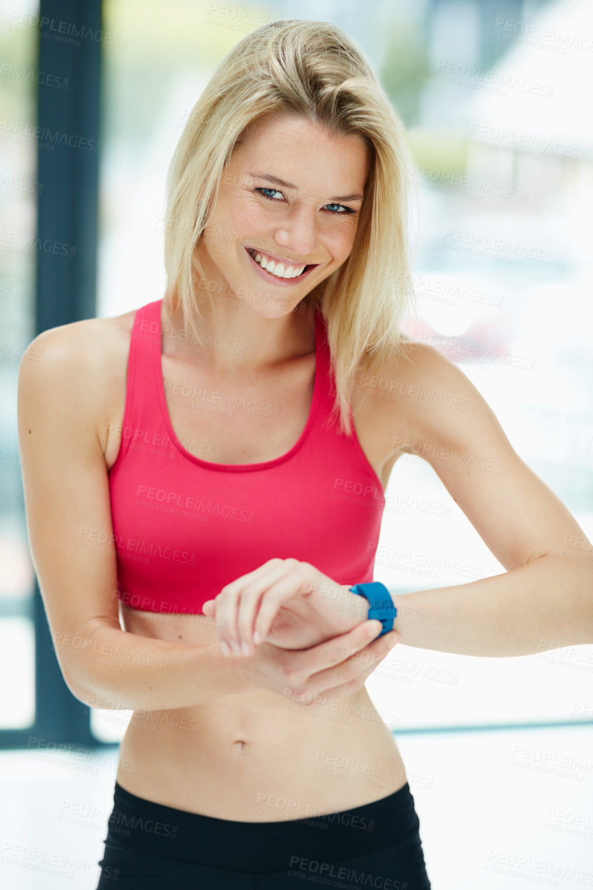 Buy stock photo Cropped portrait of an attractive young woman checking the time during a workout