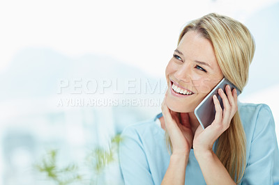 Buy stock photo Cropped shot of a young businesswoman talking on a cellphone in an office