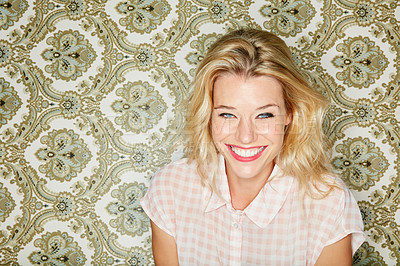 Buy stock photo Shot of a young woman posing against a wallpaper background