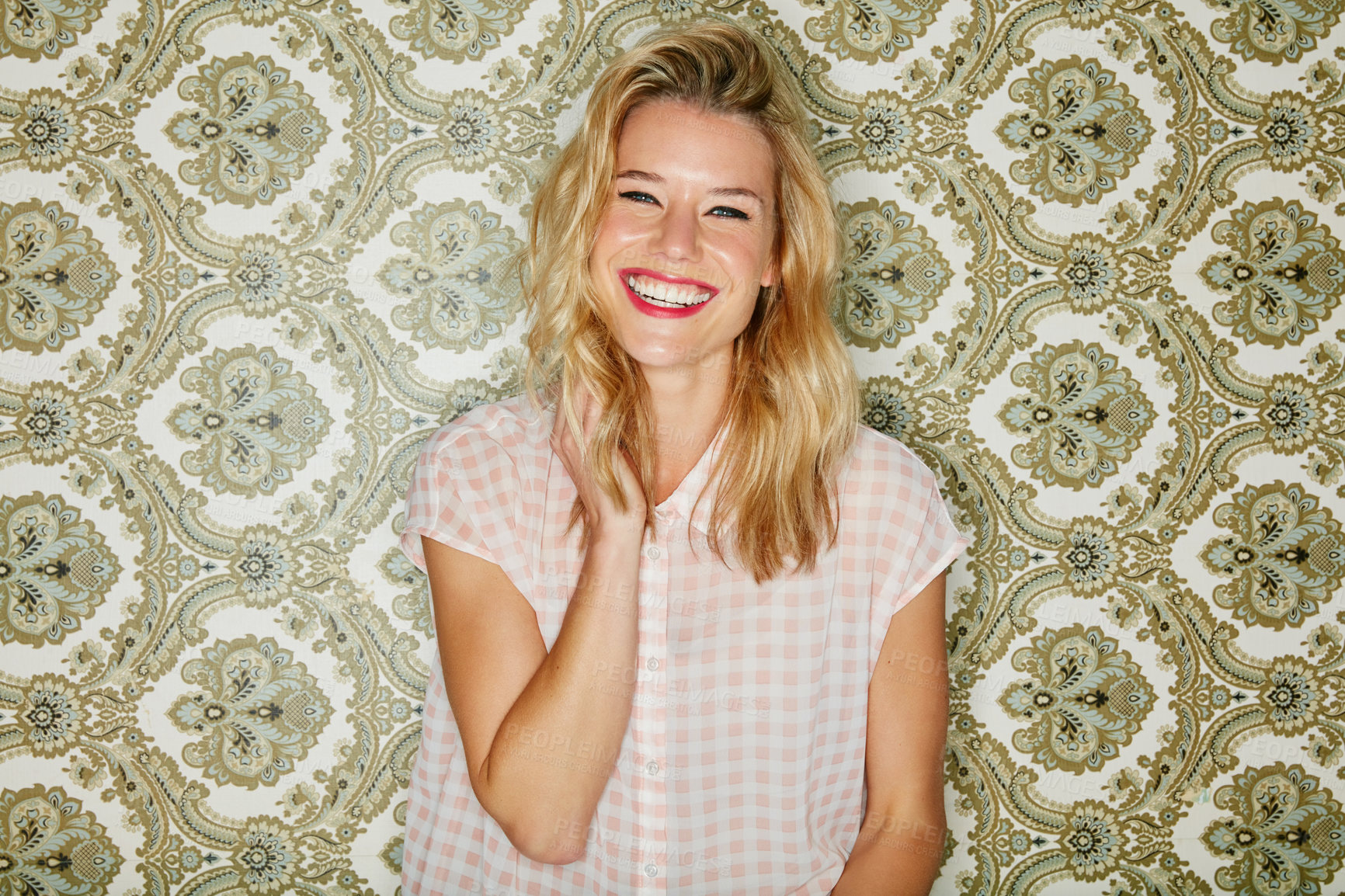 Buy stock photo Shot of a young woman posing against a wallpaper background