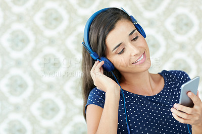 Buy stock photo Studio shot of a young woman listening to music