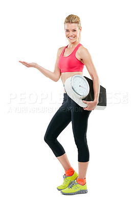 Buy stock photo Studio shot of an athletic young woman holding a scale