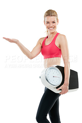 Buy stock photo Studio shot of an athletic young woman holding a scale