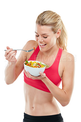 Buy stock photo Studio shot of an athletic young woman eating a bowl of salad