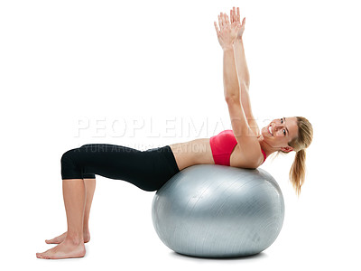 Buy stock photo Studio shot of a young woman working out with her exercise ball