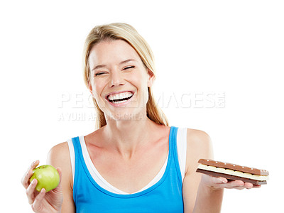 Buy stock photo Studio shot of a woman deciding between healthy and unhealthy foods