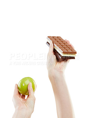 Buy stock photo Studio shot of a woman deciding between healthy and unhealthy foods