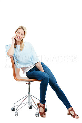 Buy stock photo Studio portrait of a happy young woman sitting on a chair against a white background