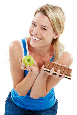 Buy stock photo Studio shot of a woman deciding between healthy and unhealthy foods