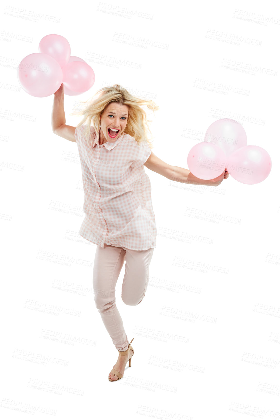 Buy stock photo Studio portrait of an excited young woman celebrating with pink balloons against a white background