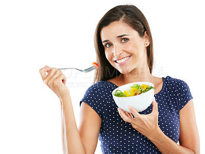 Buy stock photo Studio portrait of an attractive young woman eating a healthy salad against a white background