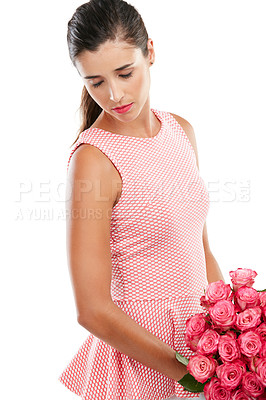 Buy stock photo Studio shot of a young woman holding a bouquet of flowers and looking sad against a white background