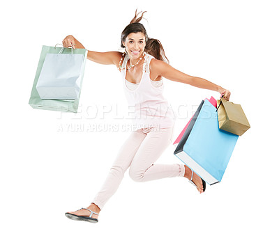 Buy stock photo Studio portrait of a happy young woman carrying shopping bags against a white background