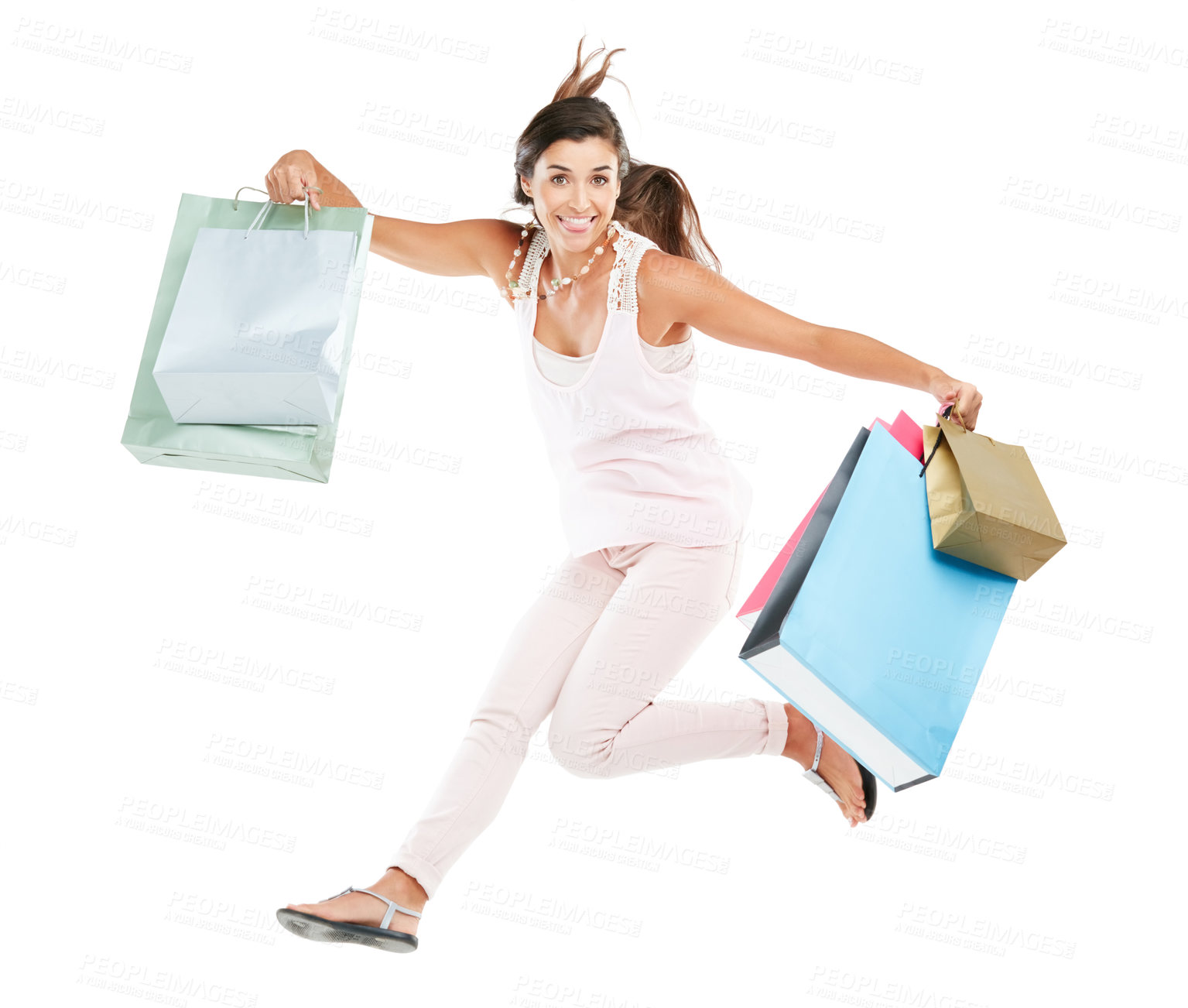 Buy stock photo Studio portrait of a happy young woman carrying shopping bags against a white background