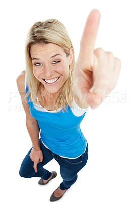 Buy stock photo Studio Studio shot of a young woman pointing towards something of an attractive young woman isolated on white