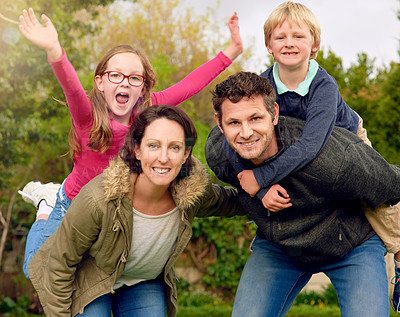 Buy stock photo Portrait of a young family standing outside together