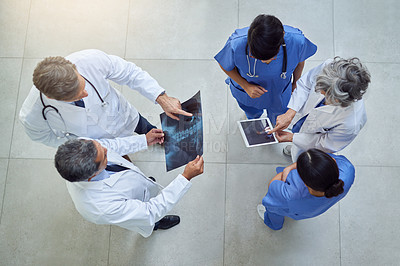 Buy stock photo High angle shot of a group of medical practitioners working together in a hospital