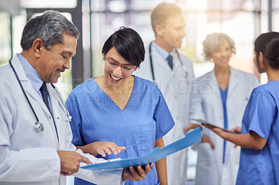 Buy stock photo Cropped shot of a group of medical practitioners working together in a hospital