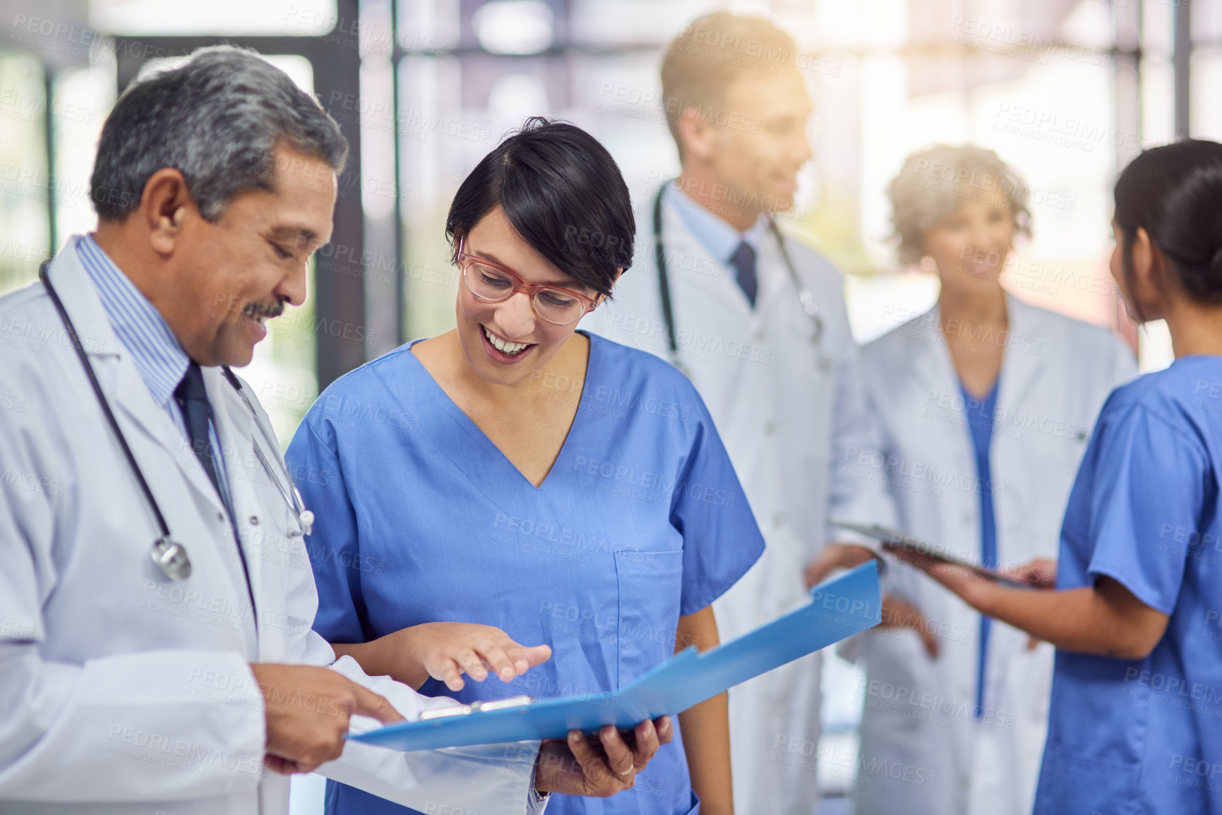 Buy stock photo Cropped shot of a group of medical practitioners working together in a hospital