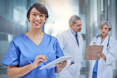 Buy stock photo Woman, doctor and tablet in hospital or portrait for medical, check on digital file for schedule. Female surgeon, medicine and tech with colleagues in clinic and working for career in healthcare