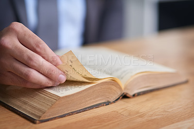Buy stock photo Cropped shot of an unidentifiable man reading a book