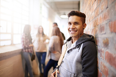 Buy stock photo Education, smile and portrait of man in college hallway for studying, learning and scholarship. Future, happy and knowledge with student relax on brick wall for university, academy and campus
