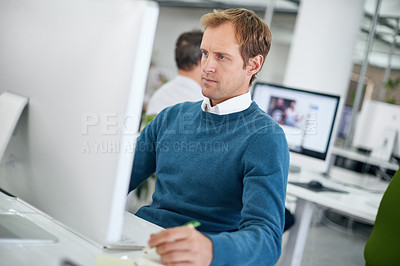 Buy stock photo Professional, serious and business man in office with computer for project planning, research or searching web. Analyst, technology and employee at desk for concentration, taking notes or information