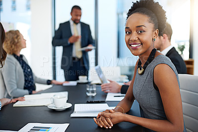 Buy stock photo Portrait of a young businesswoman working in the boardroom with her colleagues in the background