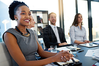 Buy stock photo Shot of a group of corporate businesspeople sitting in the boardroom