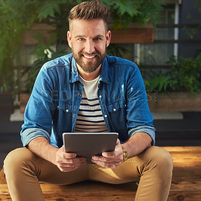 Buy stock photo Portrait of a handsome young man using a digital tablet