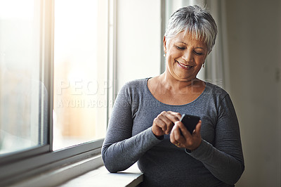 Buy stock photo Window, smile and senior woman with a smartphone, connection and social media at home. Mature female, person and old lady with a cellphone, email and mobile app with network, happiness and typing