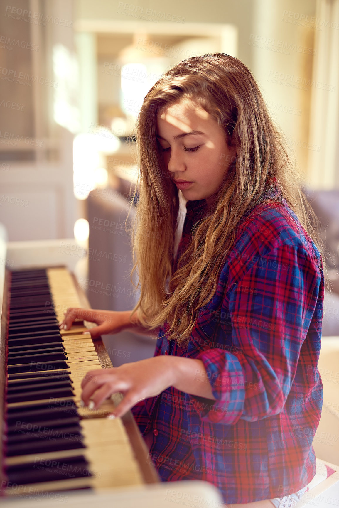 Buy stock photo Cropped shot of a young girl playing the piano